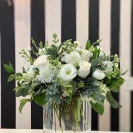 White floral arrangement in a clear glass vase