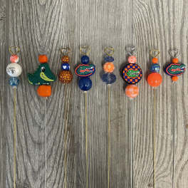 Decorative beaded picks with heart toppers and Florida Gators charms