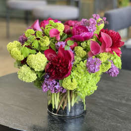 Bright pink and lime green floral arrangement in a glass vase