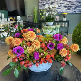 Bright mixed flower arrangement in a white bowl vase