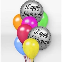 Cluster of colorful balloons with two silver "Happy Anniversary" balloons