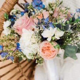 Hand-tied bouquet of pink, white, and blue flowers
