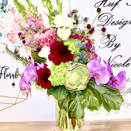 Colorful mixed flower arrangement in a clear glass vase