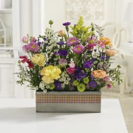 Mixed bouquet of colorful flowers in a rectangular box