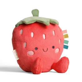 Plush strawberry-shaped toy with a smiling face and colorful tags