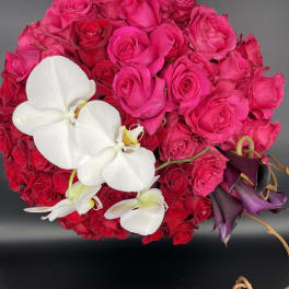 Bouquet of hot pink roses with white orchids and dark purple calla lilies