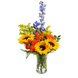 Bouquet of sunflowers, orange carnations, and blue delphinium in a clear glass vase