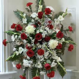 Standing floral spray with red roses, white flowers, and carnations