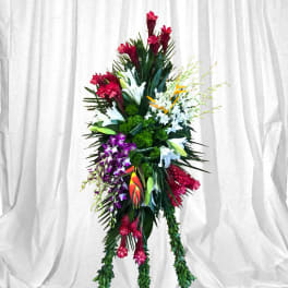 Tall tropical floral standing spray with red, white, purple, and orange blooms