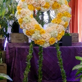 Heart-shaped floral standing spray with yellow and cream roses