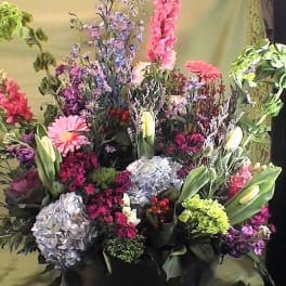 Large mixed floral arrangement with lilies, hydrangeas, and gerbera daisies