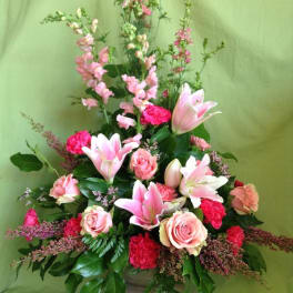 Tall pink and white floral arrangement in a vase