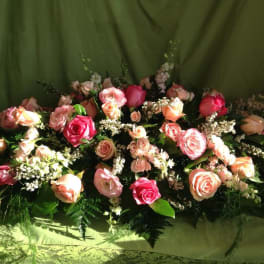 Arrangement of pink and peach roses with white filler flowers