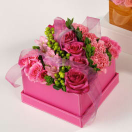Pink roses and carnations in a pink gift box with sheer ribbon