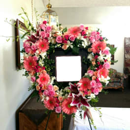 Heart-shaped floral wreath with pink roses and gerbera daisies