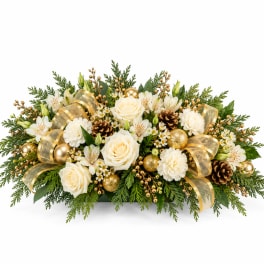 Holiday floral arrangement with white roses, carnations, and gold accents