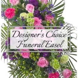 Pink and purple funeral easel spray with roses and carnations