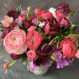 Mixed pink and purple bouquet in a white vase