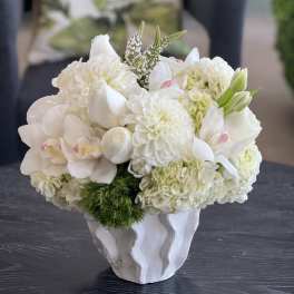 White floral arrangement in a sculpted white vase