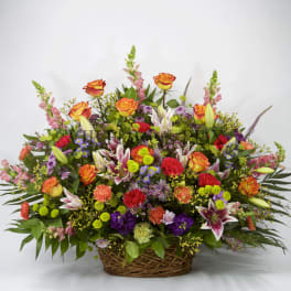 Large mixed flower basket with orange roses and lilies