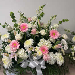 Large bouquet of pink and white flowers with a silver ribbon
