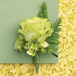 Green boutonniere with a pale rose and foliage