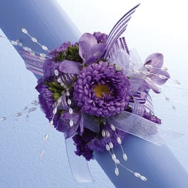 Purple floral bouquet with ribbon and beaded accents