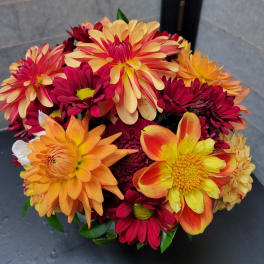 Bouquet of orange, yellow, and burgundy daisies