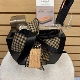 Gift basket with beard brush and grooming items tied with plaid ribbon