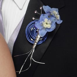 Blue flower boutonniere pinned to a black suit jacket