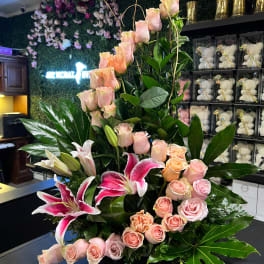 Tall floral arrangement with pink roses and pink lilies