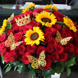 Large bouquet of red roses with yellow sunflowers and butterfly decorations