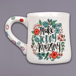 White mug with floral lettering that says "Make Today Amazing"