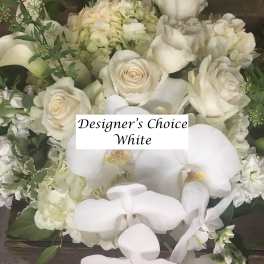 White roses and orchids in a dense floral arrangement