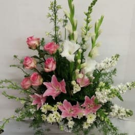 Tall floral arrangement with pink roses, pink lilies, and white gladiolus