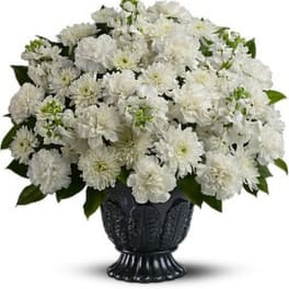 White chrysanthemum bouquet in a dark urn vase