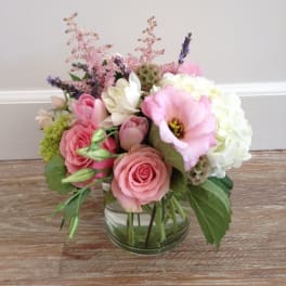 Pink roses and white hydrangea in a clear glass vase