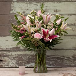 Pink and white mixed bouquet in a clear glass vase