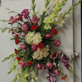 Tall mixed floral spray with pink, red, white, and purple blooms