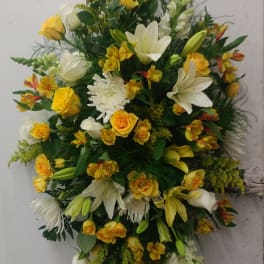 Large yellow and white floral spray with lilies and roses