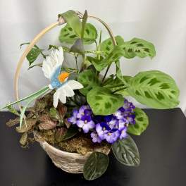 Basket planter with green foliage, purple flowers, and a decorative bird