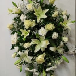 White lilies and roses arranged in a large standing spray
