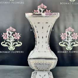 Decorative silver mosaic pedestal vase on a black backdrop