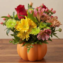 Mixed bouquet in an orange pumpkin-shaped container