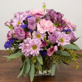 Lavender and pink bouquet in a clear square vase