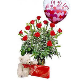 Bouquet of red roses with a heart balloon, teddy bear, and gift box