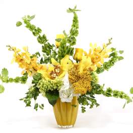 Yellow and white floral arrangement in a gold vase