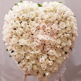 Large heart-shaped bouquet of white roses on a stand