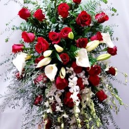 Large standing arrangement of red roses and white calla lilies