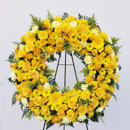 Yellow floral wreath on a black stand